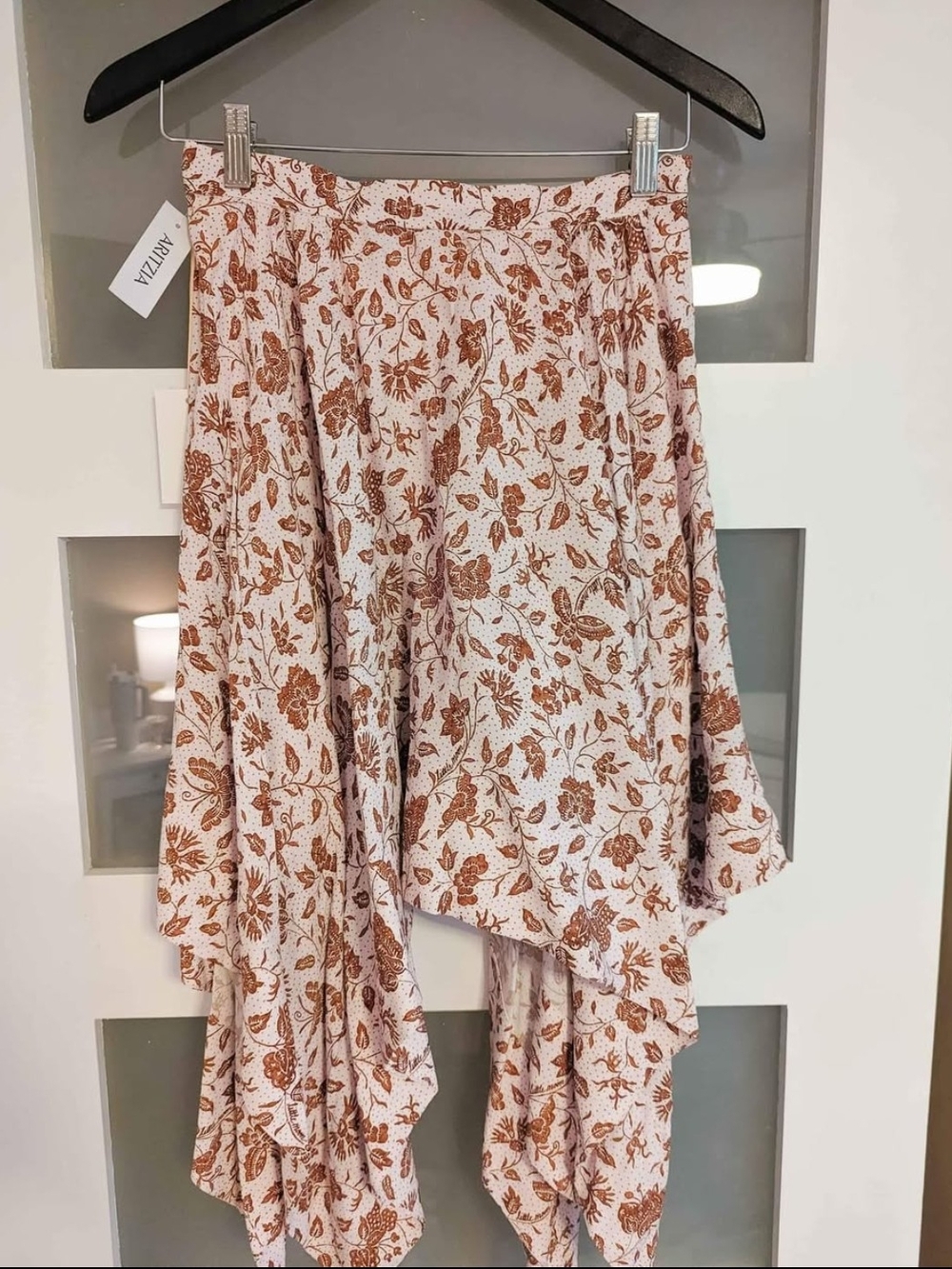 Aritzia Floral Asymmetrical Midi Skirt in Rust on light pink.